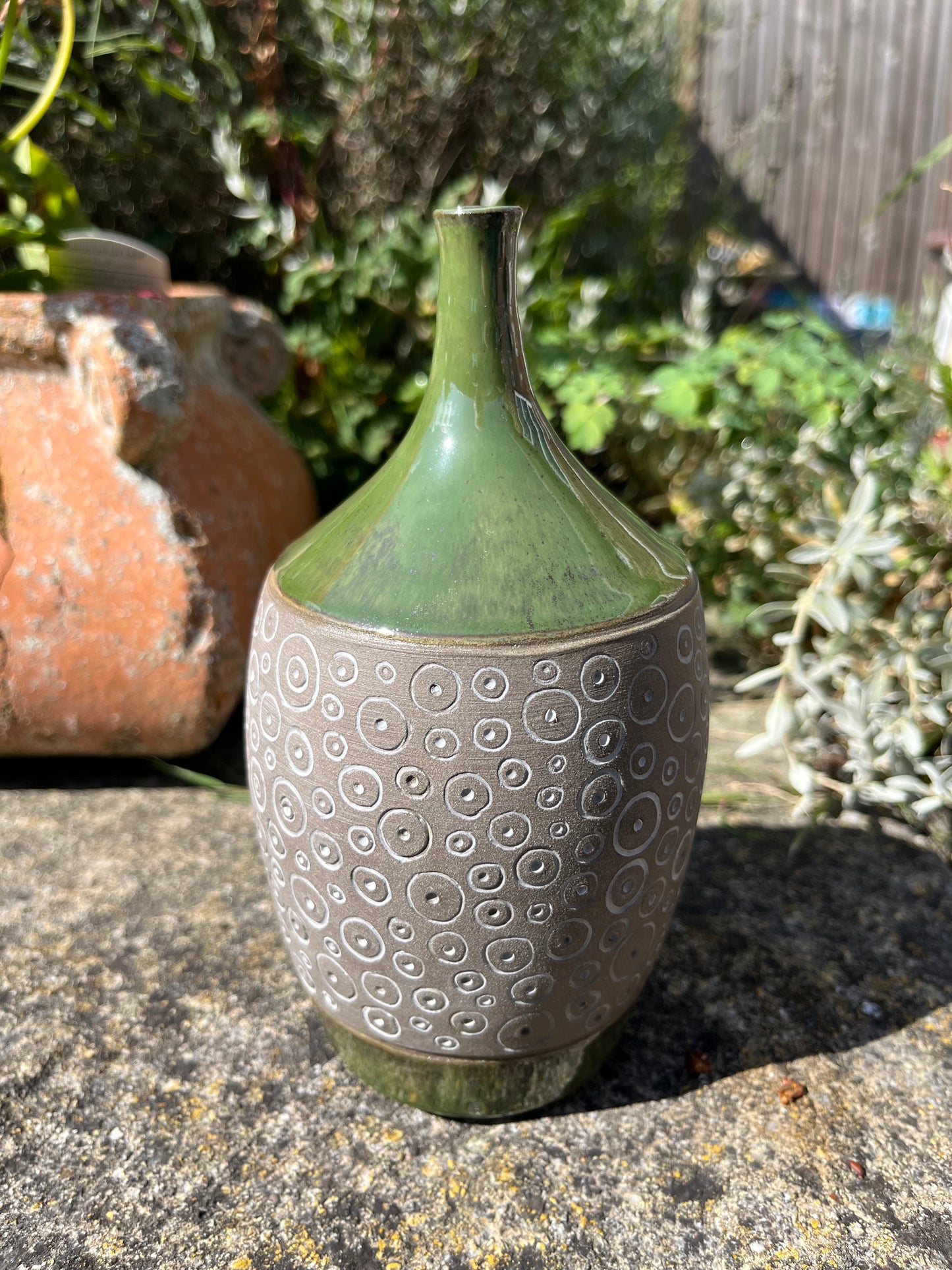 Carved pottery green narrow-necked bottle